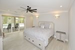 Master Bedroom with direct access to screen enclosed patio & pool deck.